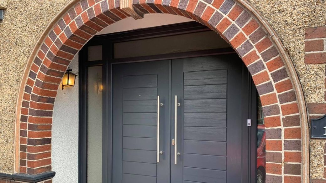 Professional door installation with a unique curved design